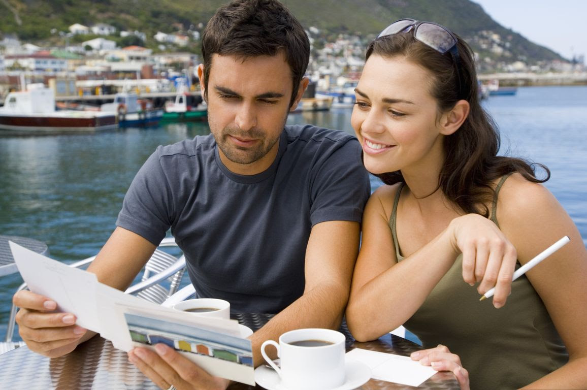 Couple writing postcards